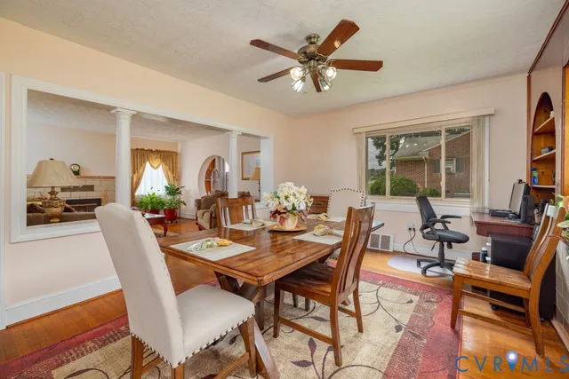 a dining room with furniture a rug and a chandelier