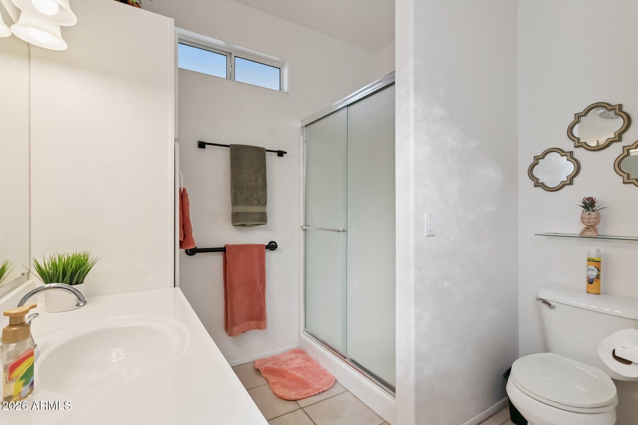 17200 West Bell Road, Unit 869 Surprise, AZ 85374 - Photo 19 of 25 a bathroom with a granite countertop sink and a mirror