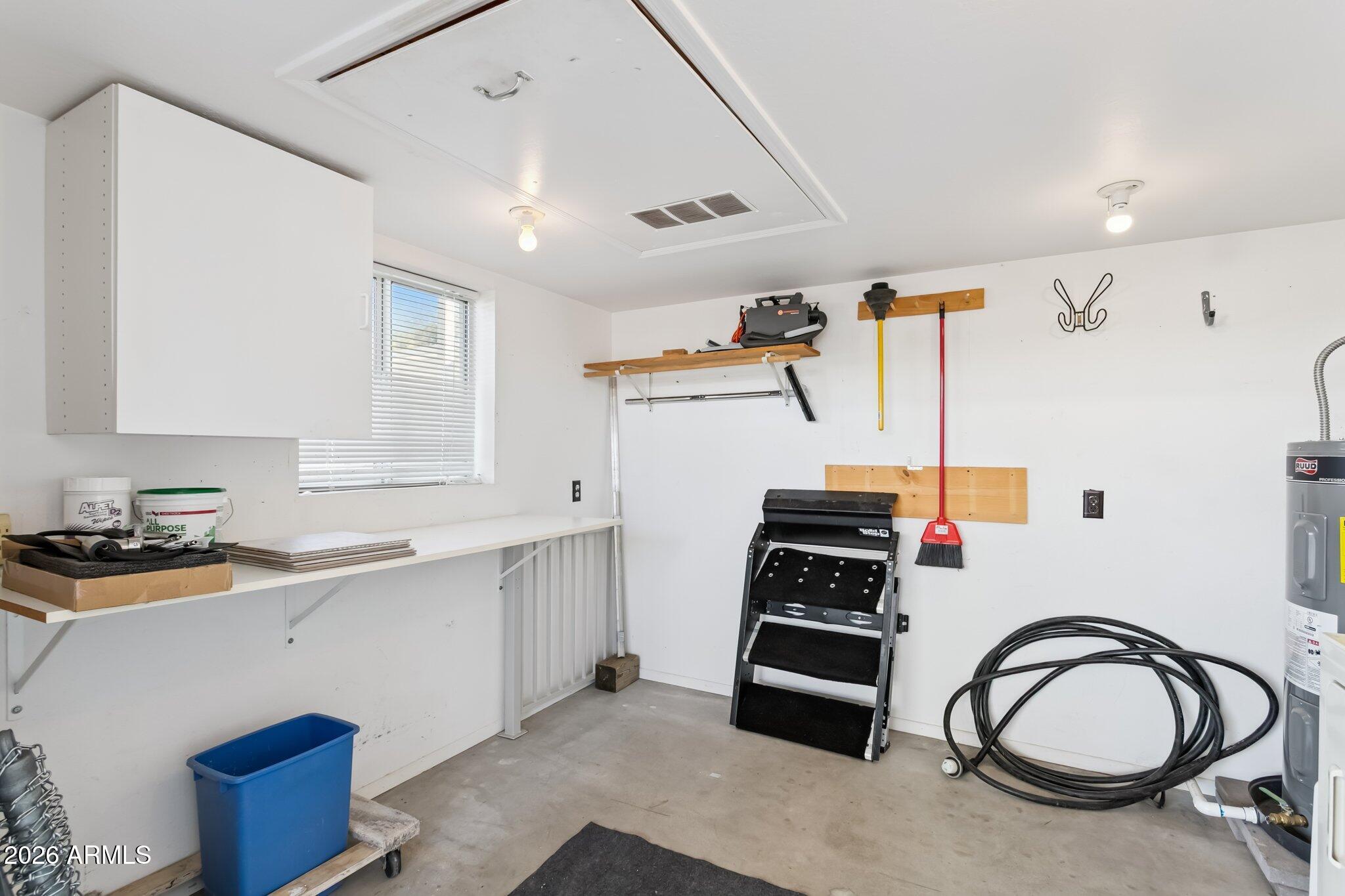 17200 West Bell Road, Unit 869 Surprise, AZ 85374 - Photo 21 of 25 a kitchen with a sink a stove and white cabinets