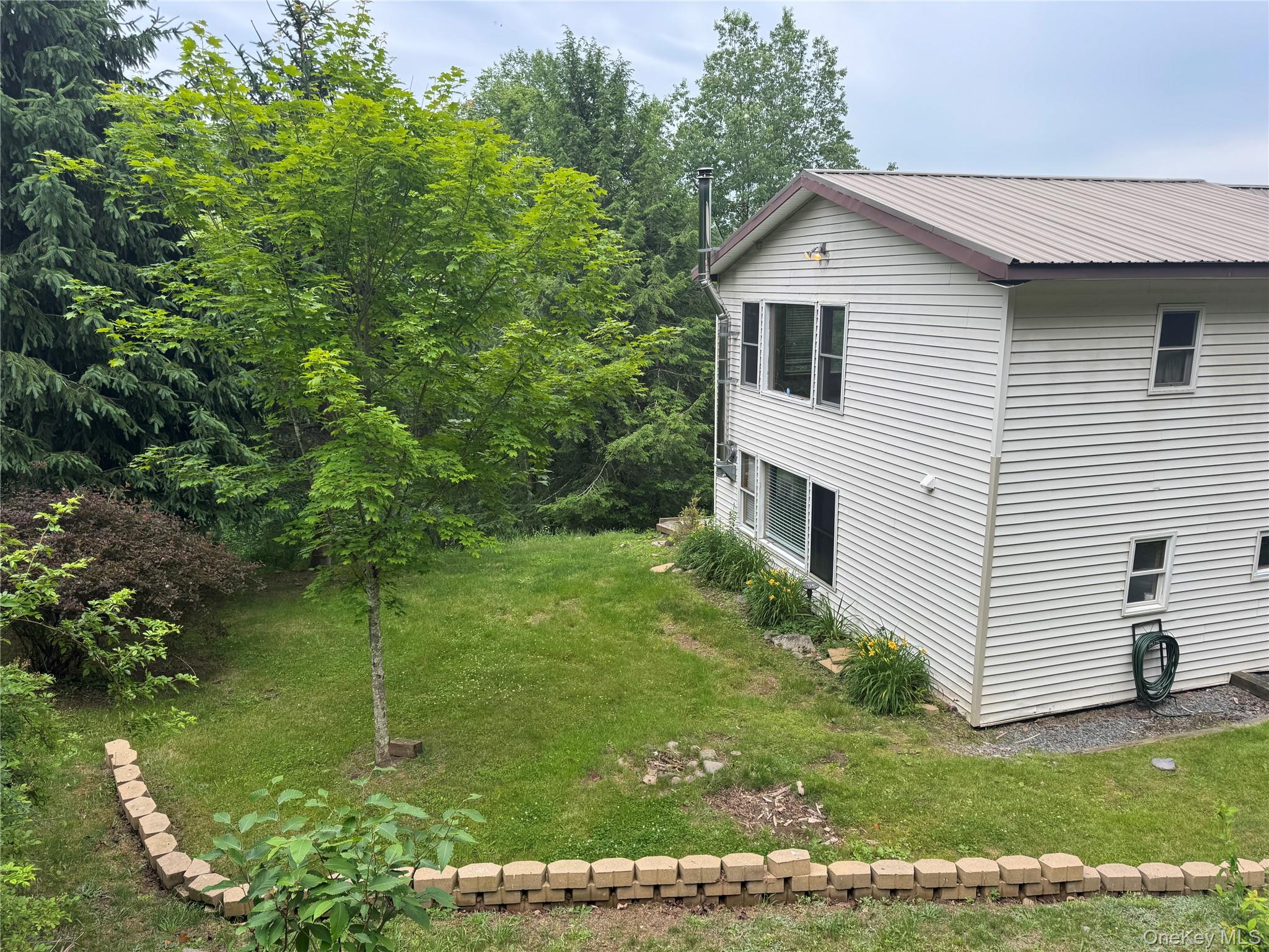 96 White Roe Lake Road Livingston Manor, NY 12758 - Photo 4 of 34 a house view with a garden space
