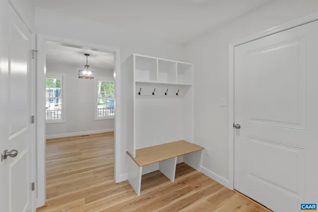 a view of empty room with wooden floor and fireplace