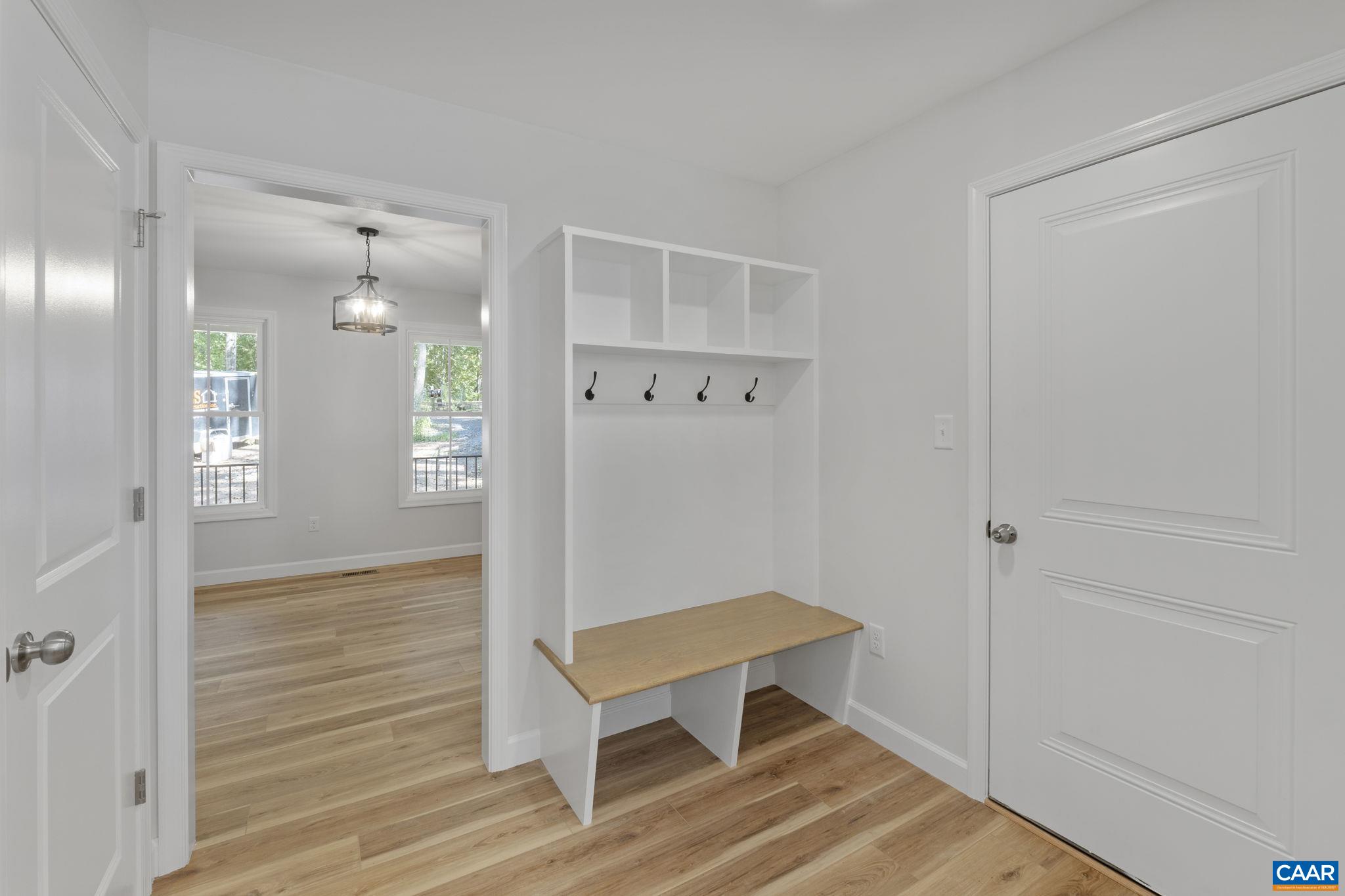 6 Condor Road Palmyra, VA 22963 - Photo 14 of 65 a view of a hallway with wooden floor and a bathroom