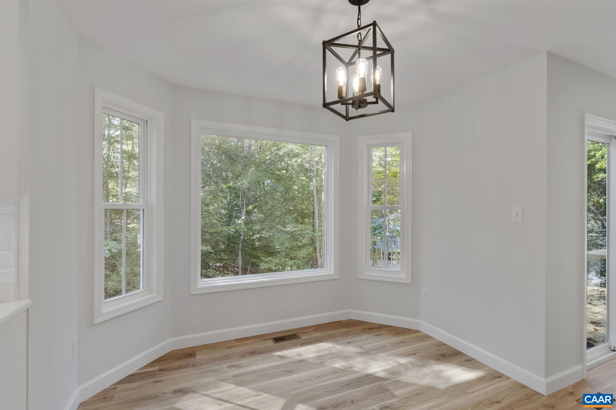 6 Condor Road Palmyra, VA 22963 - Photo 21 of 65 a view of an empty room with wooden floor and chandelier