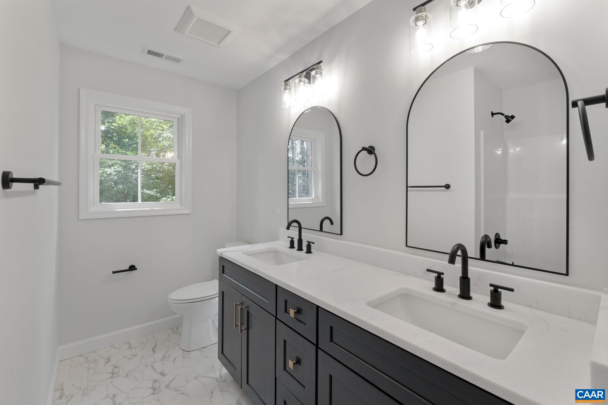 6 Condor Road Palmyra, VA 22963 - Photo 29 of 65 a bathroom with a double vanity sink and a mirror