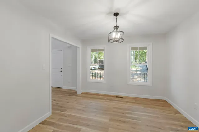 a house that has a tree in front of it