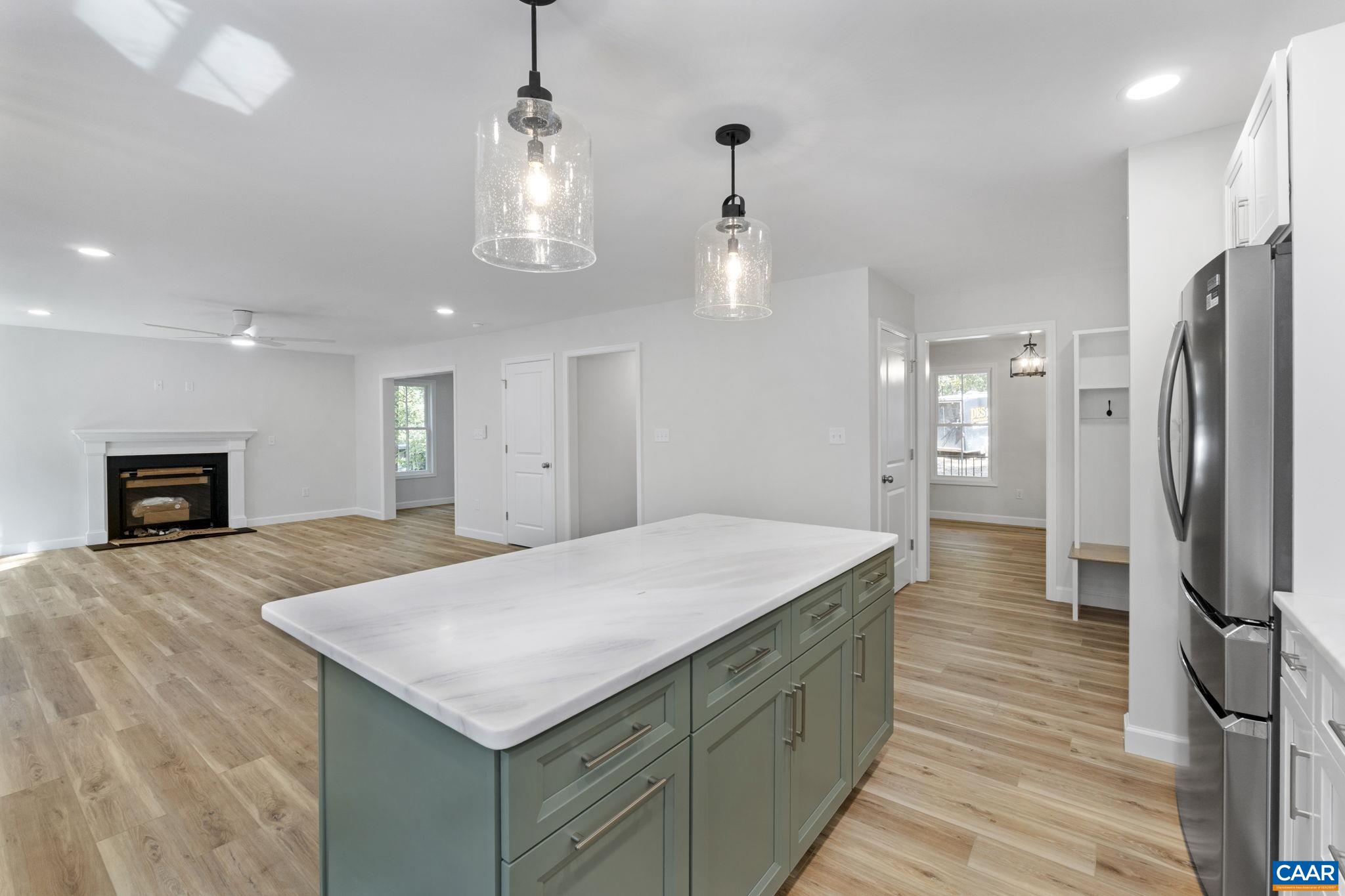 6 Condor Road Palmyra, VA 22963 - Photo 9 of 65 a kitchen with kitchen island white cabinets and stainless steel appliances