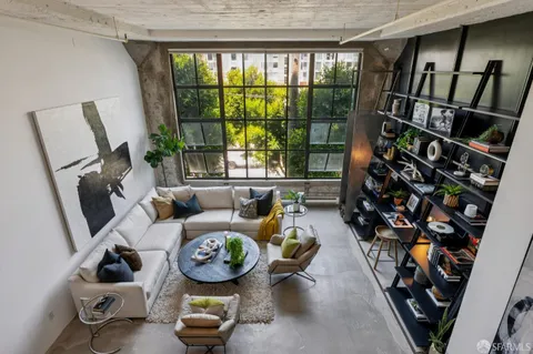a living room with furniture and a floor to ceiling window