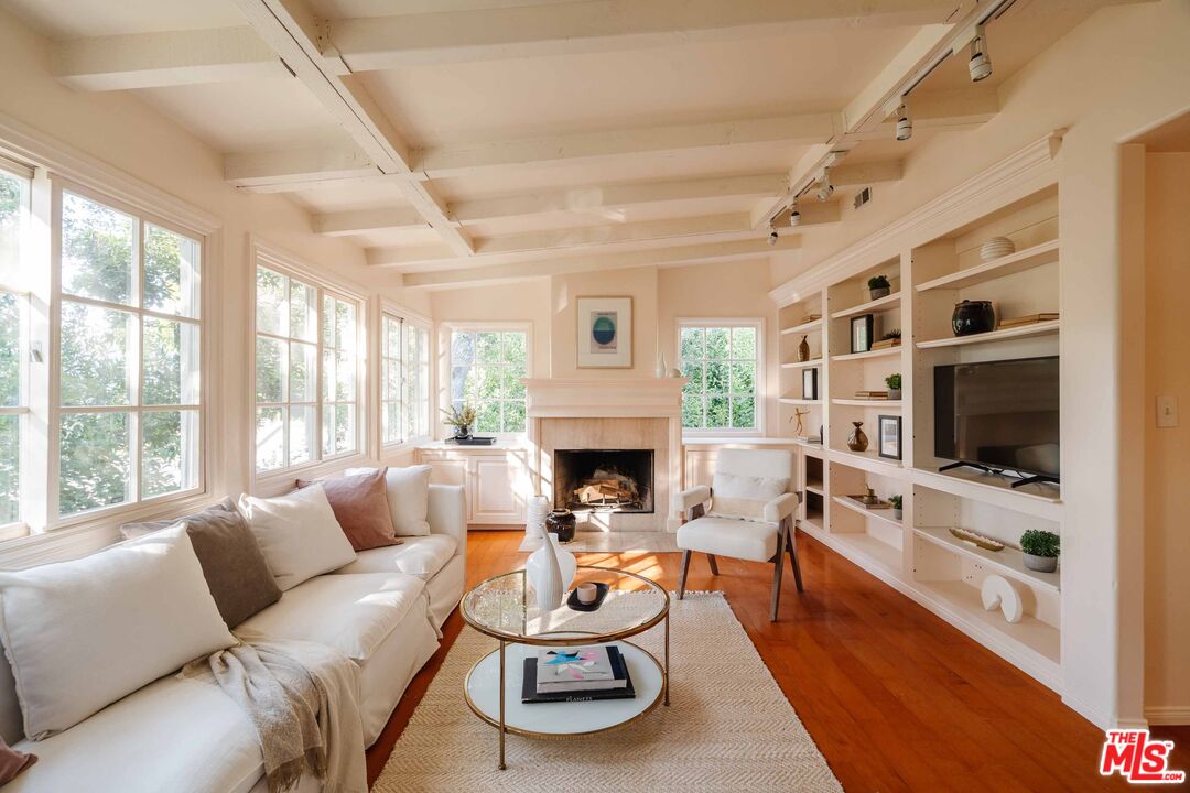 21580 Encina Road Topanga, CA 90290 - Photo 15 of 38 a living room with furniture flat screen tv and a fireplace