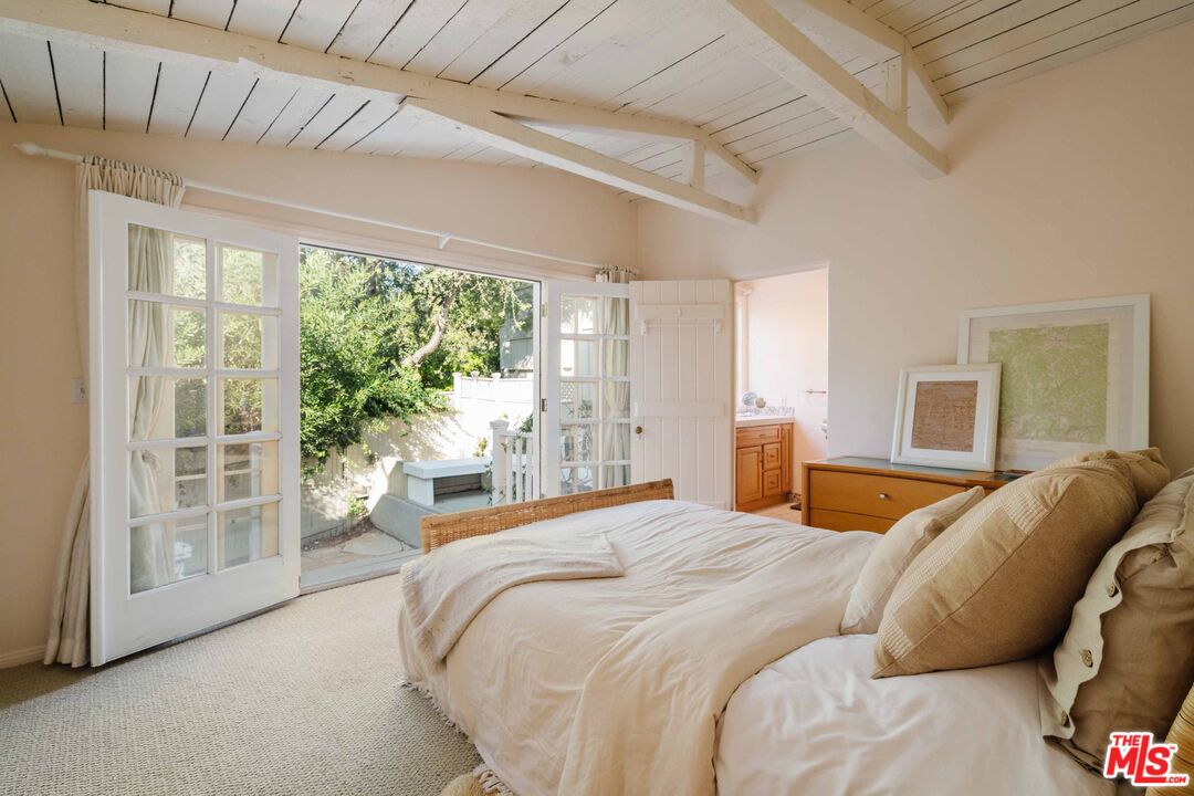 21580 Encina Road Topanga, CA 90290 - Photo 17 of 38 a bedroom with a bed and a large window