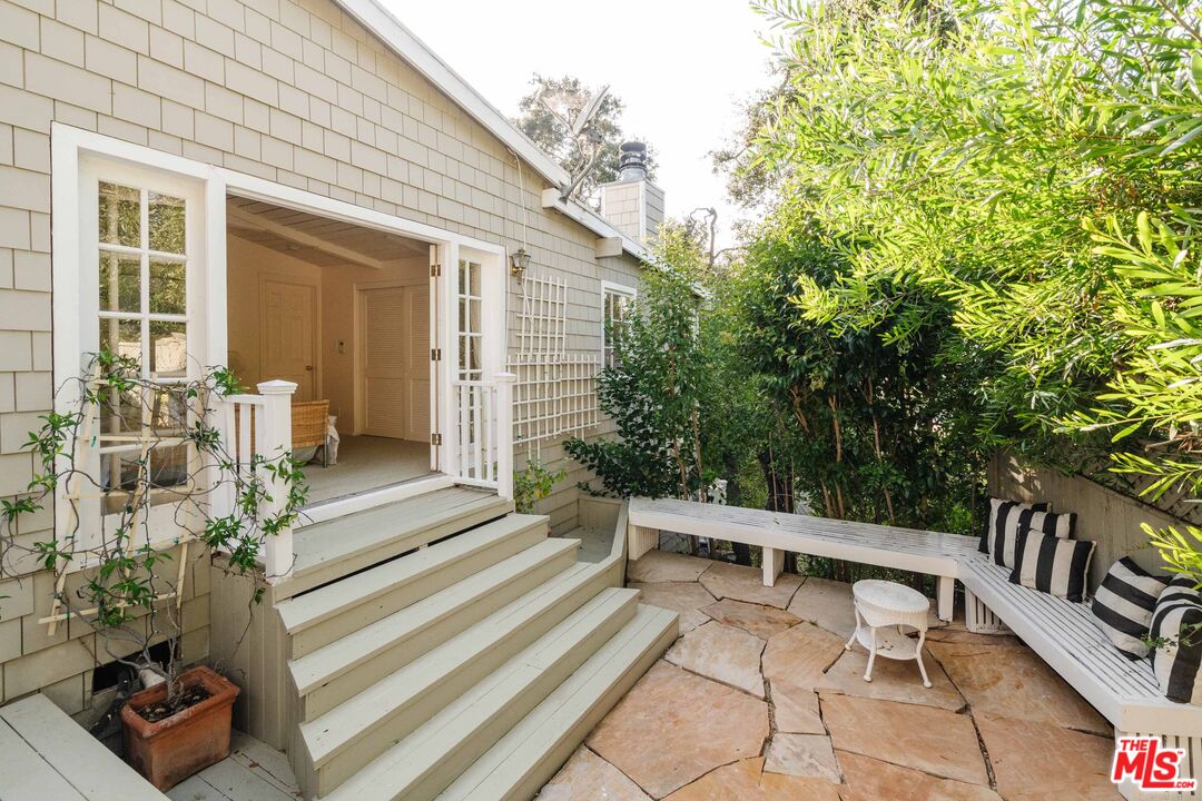 21580 Encina Road Topanga, CA 90290 - Photo 20 of 38 a balcony with wooden floor and outdoor seating