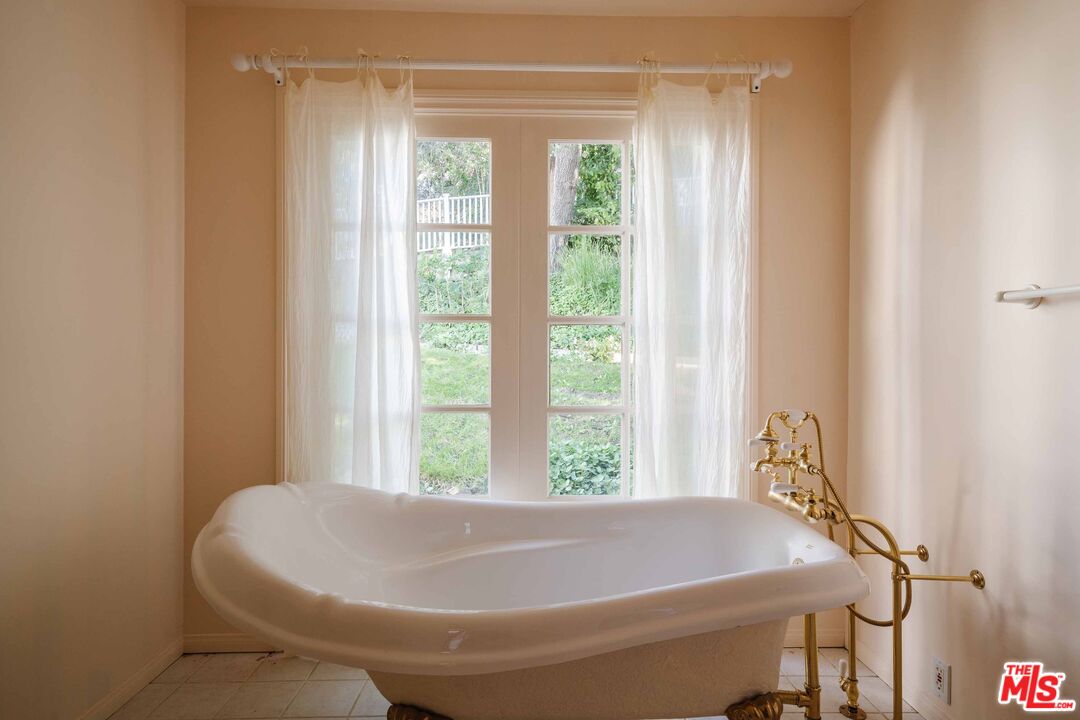 21580 Encina Road Topanga, CA 90290 - Photo 22 of 38 a bath tub sitting in a bathroom next to a window