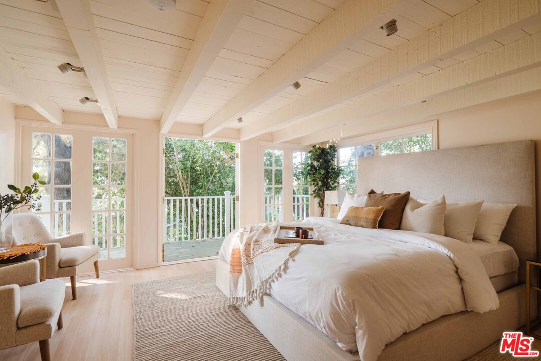 21580 Encina Road Topanga, CA 90290 - Photo 23 of 38 a bed room with a bed and a large window