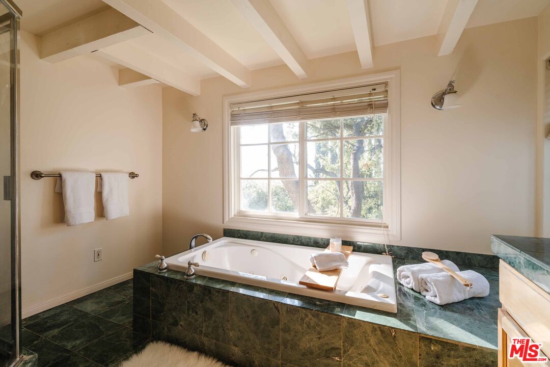 21580 Encina Road Topanga, CA 90290 - Photo 26 of 38 a bath room with a window and a bath tub