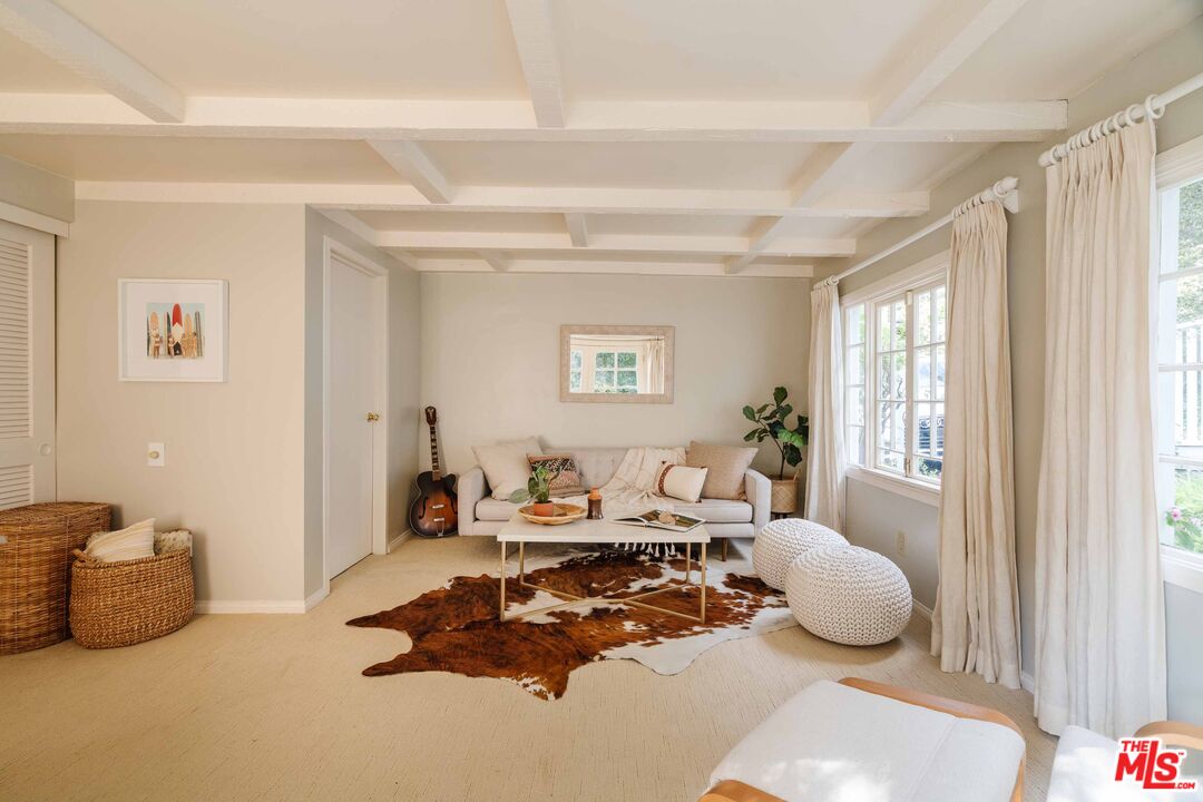 21580 Encina Road Topanga, CA 90290 - Photo 34 of 38 a living room with furniture a window and a table