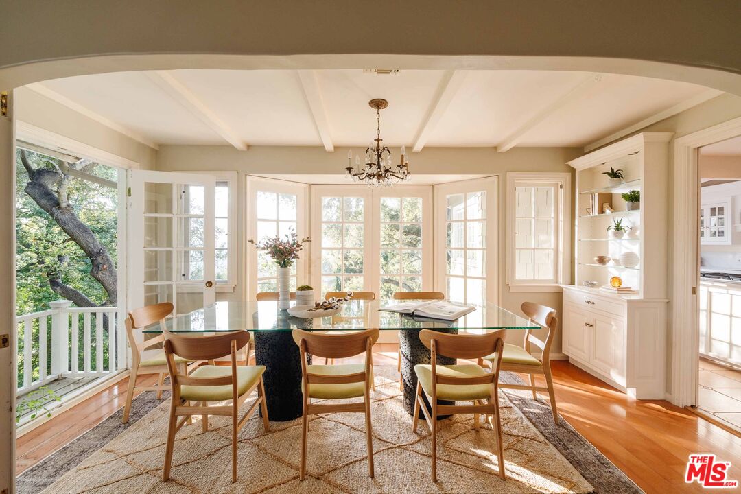 21580 Encina Road Topanga, CA 90290 - Photo 6 of 38 a dining room with furniture a chandelier and wooden floor