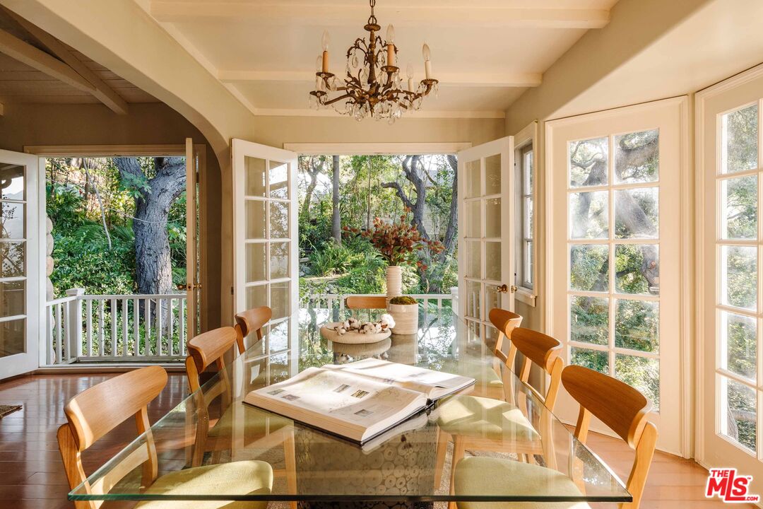 21580 Encina Road Topanga, CA 90290 - Photo 7 of 38 a view of a dining room with furniture large windows and wooden floor