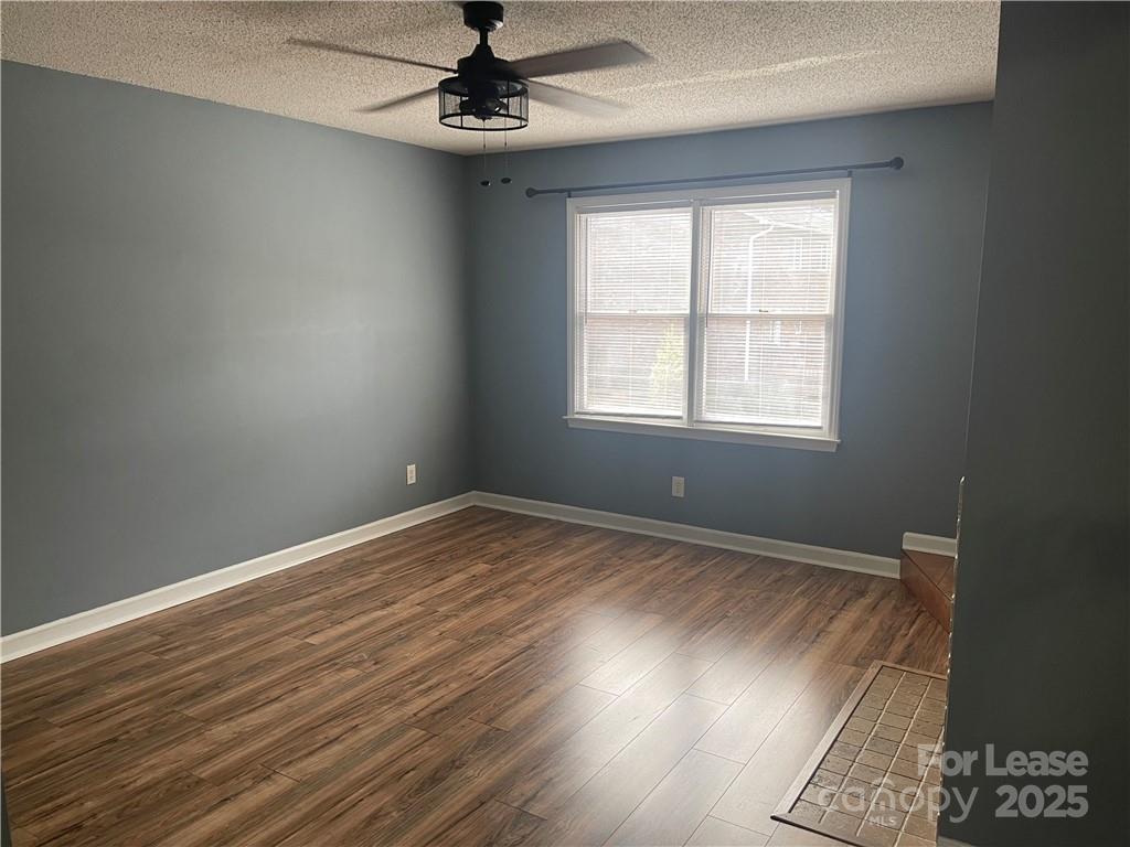 1425 20th Avenue Northeast Hickory, NC 28601 - Photo 4 of 22 an empty room with wooden floor fan and windows