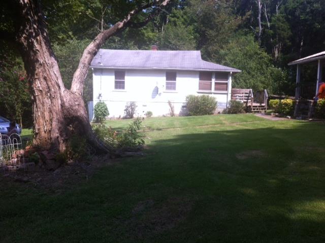 145 Maple Road Stewart, TN 37175 - Photo 1 of 4 a front view of a house with a garden