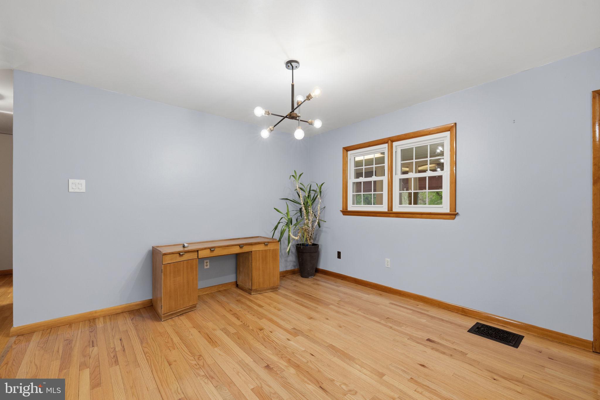 14983 Charles Town Road Charles Town, WV 25414 - Photo 16 of 80 a view of a room with wooden floor and a ceiling fan
