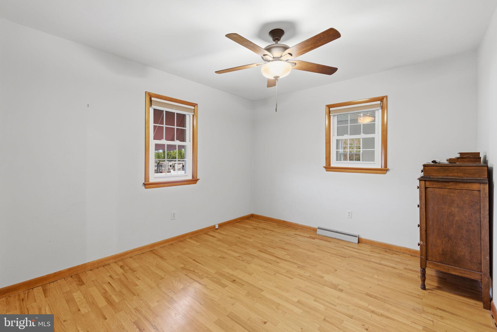 14983 Charles Town Road Charles Town, WV 25414 - Photo 31 of 80 a view of a big room with wooden floor and a ceiling fan
