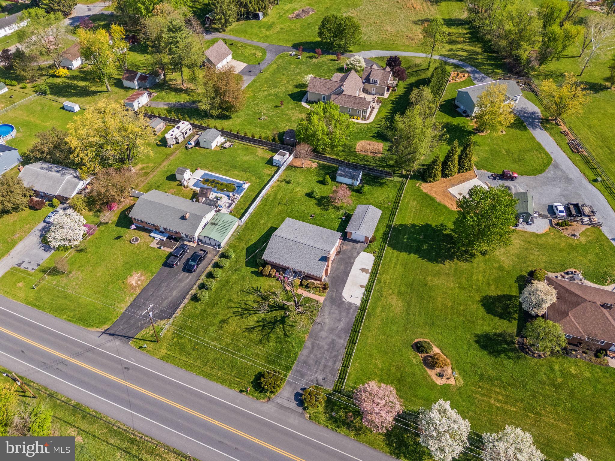 14983 Charles Town Road Charles Town, WV 25414 - Photo 62 of 80 an aerial view of swimming pool a yard and outdoor seating