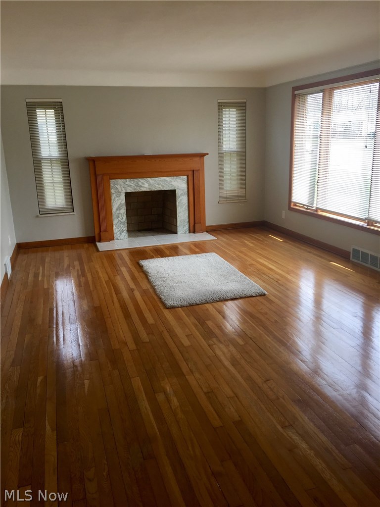 9750 Snow Road Cleveland, OH 44130 - Photo 9 of 24 Spectacular sparkling wood flooring gives a luster to the large Living Room which is enhanced by handsome Fireplace & Mantle and windows!