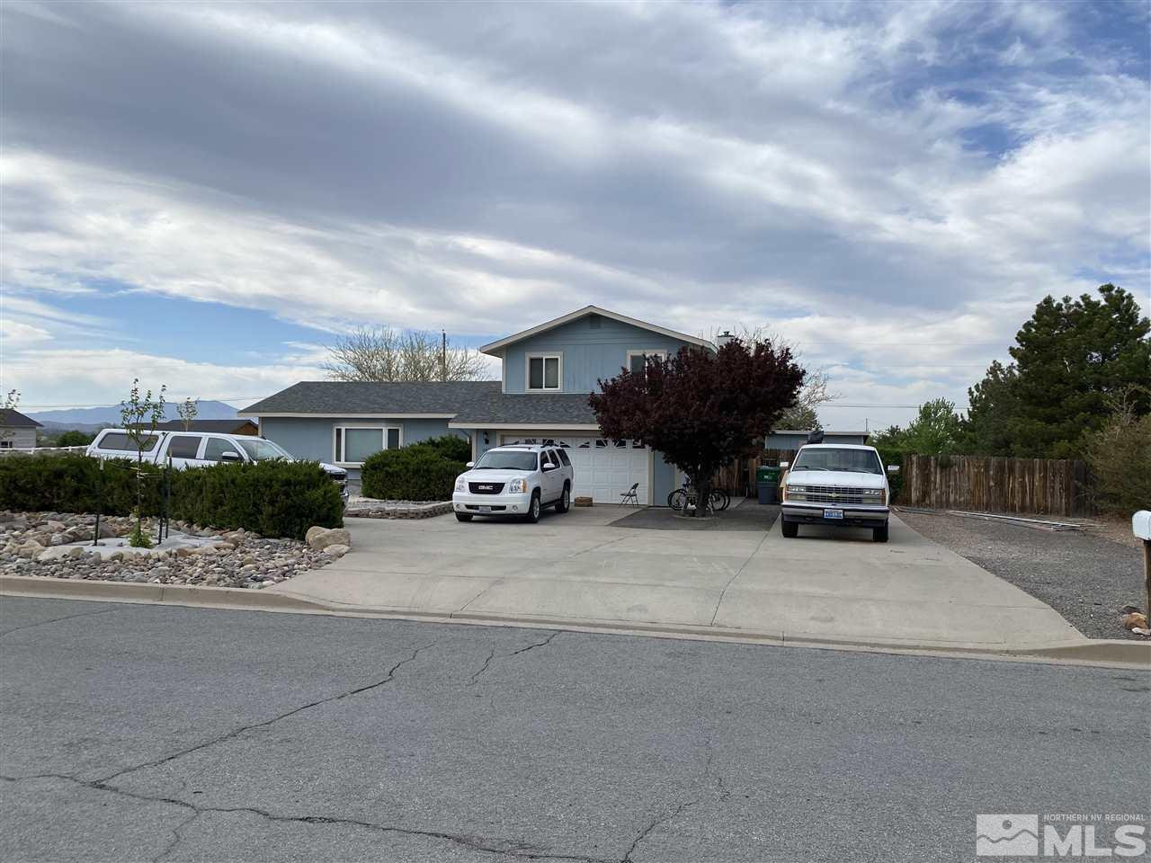 1145 Lavender Way Reno, NV 89521 - Photo 1 of 1 a car parked in front of a white house
