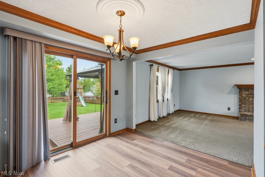5321 Young Road Stow, OH 44224 - Photo 13 of 37 Sliding glass door opening to an outdoor deck and expansive green lawn