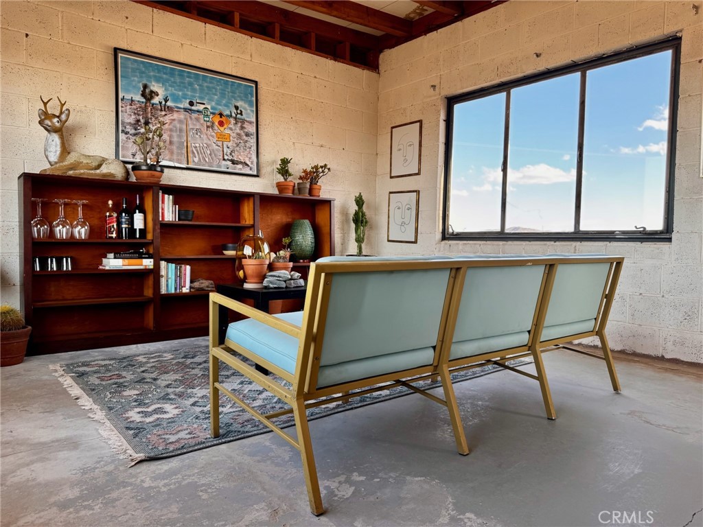 6615 Thunder Road Twentynine Palms, CA 92277 - Photo 7 of 14 a room with furniture and paintings on the wall
