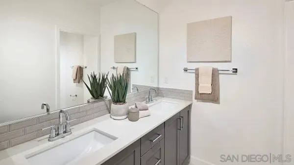 a bathroom with a double vanity sink and a mirror