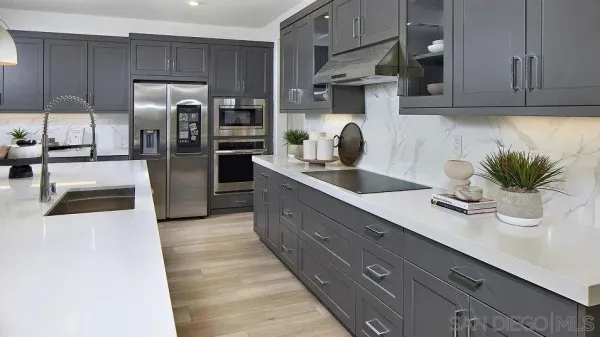 a kitchen with stainless steel appliances a sink a counter space and cabinets