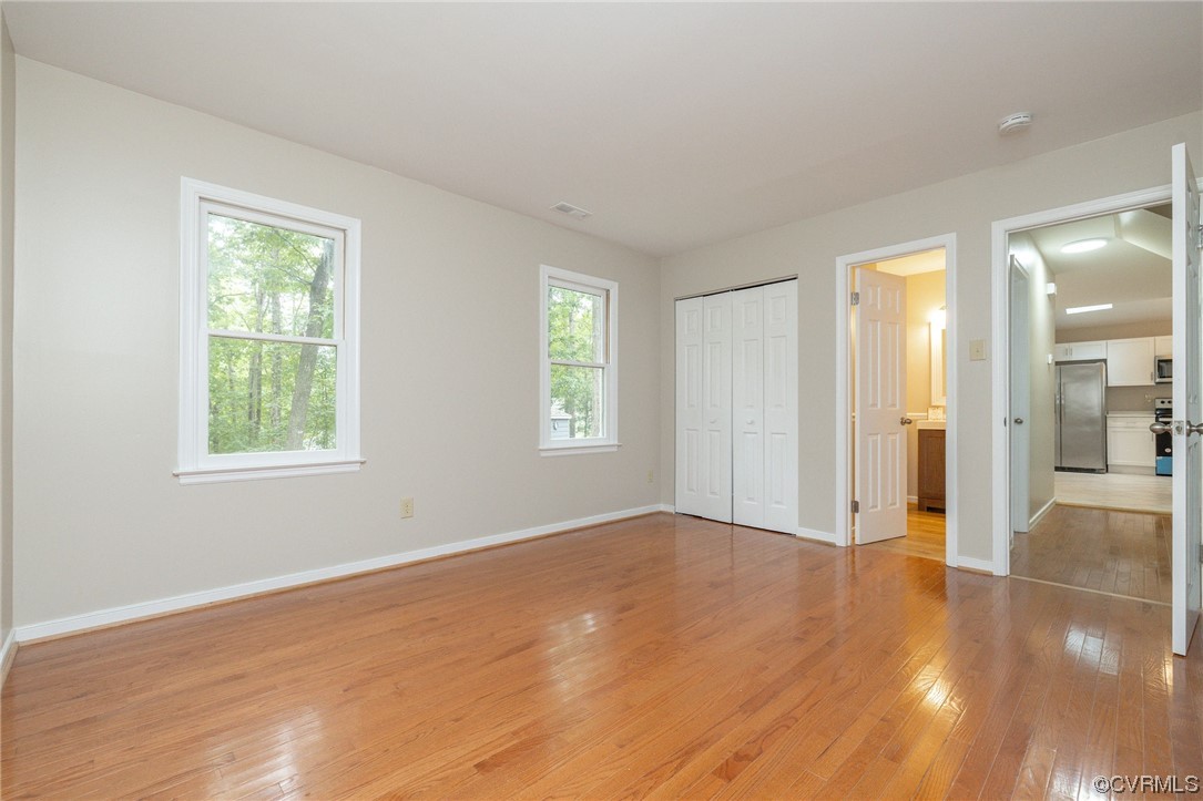 2406 Arrowood Road Midlothian, VA 23112 - Photo 24 of 39 an empty room with wooden floor and windows