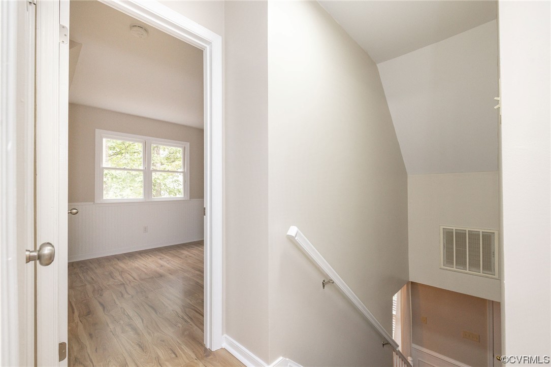 2406 Arrowood Road Midlothian, VA 23112 - Photo 25 of 39 a view of an empty room with wooden floor and a window