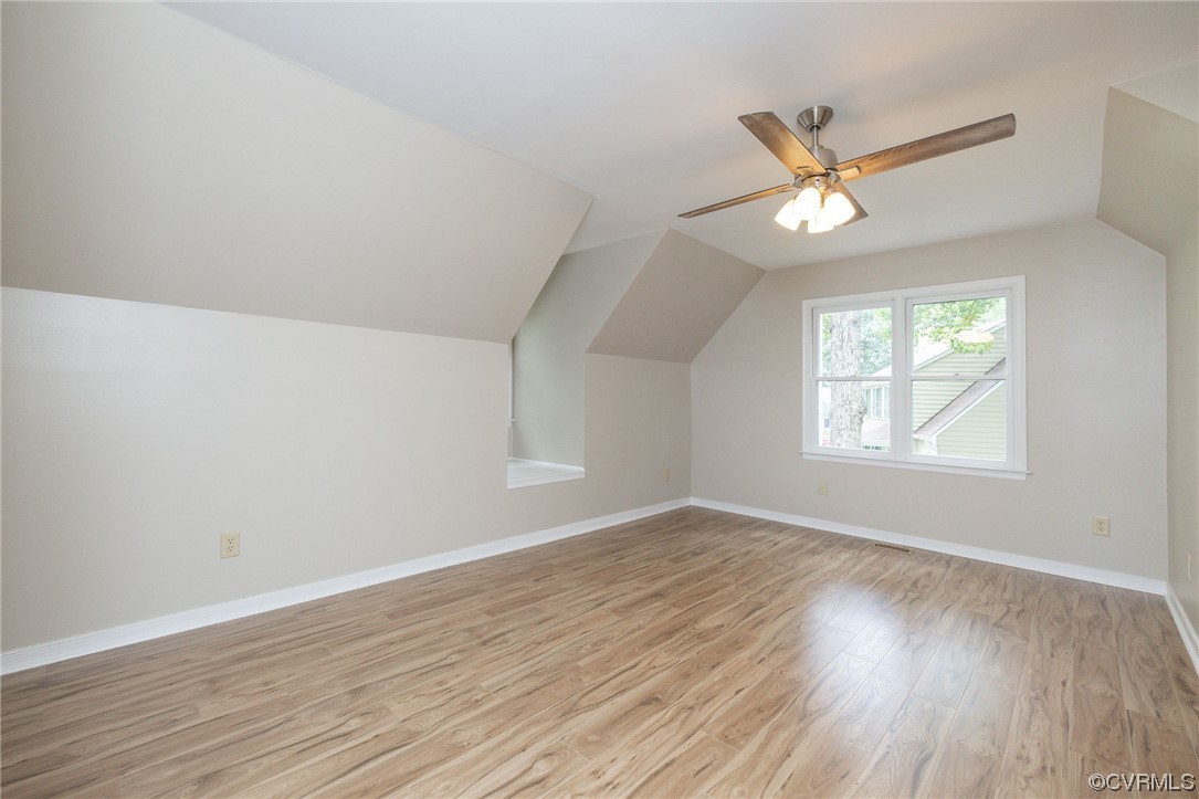 2406 Arrowood Road Midlothian, VA 23112 - Photo 31 of 39 an empty room with wooden floor fan and windows