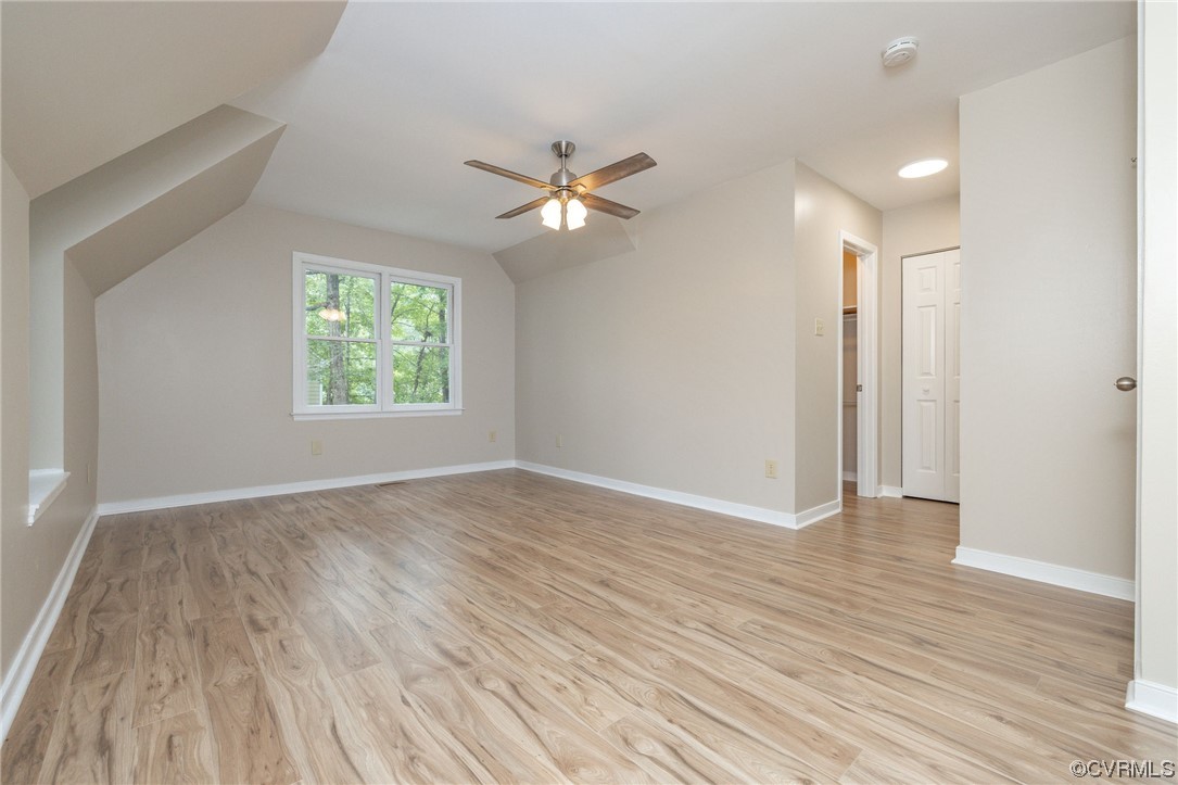 2406 Arrowood Road Midlothian, VA 23112 - Photo 32 of 39 an empty room with wooden floor ceiling fan and windows