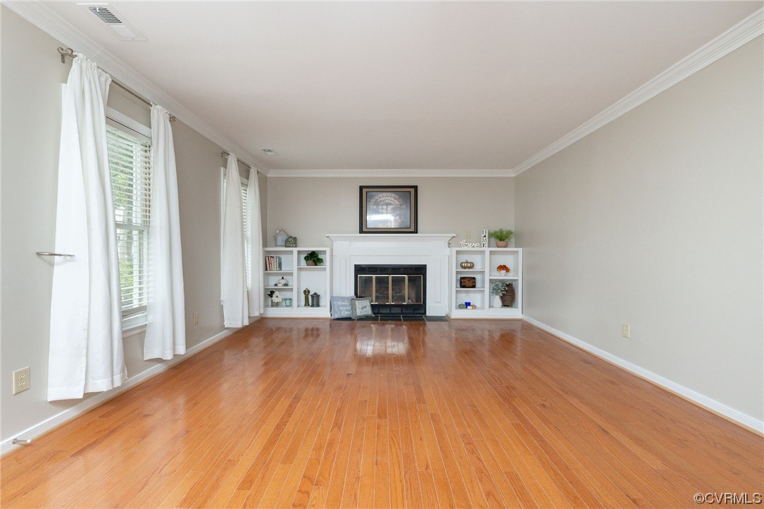 2406 Arrowood Road Midlothian, VA 23112 - Photo 6 of 39 a view of a livingroom with wooden floor and a fireplace