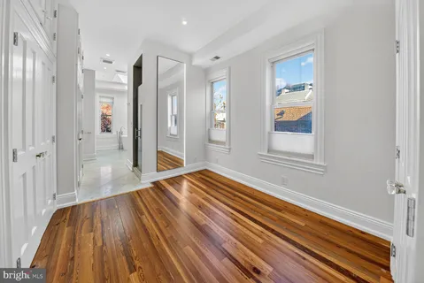 a view of a room with wooden floor and window