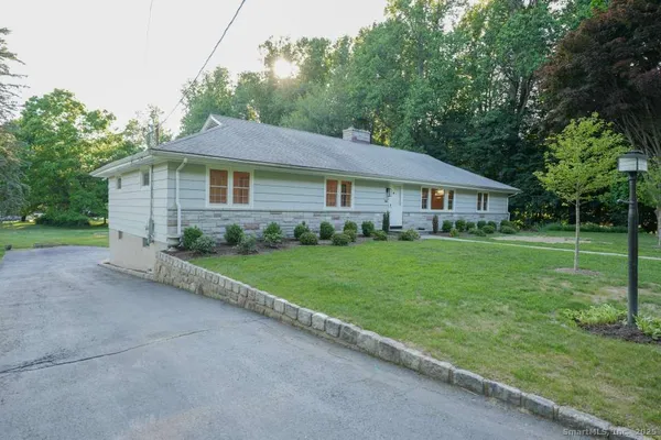 a view of house with outdoor space and yard