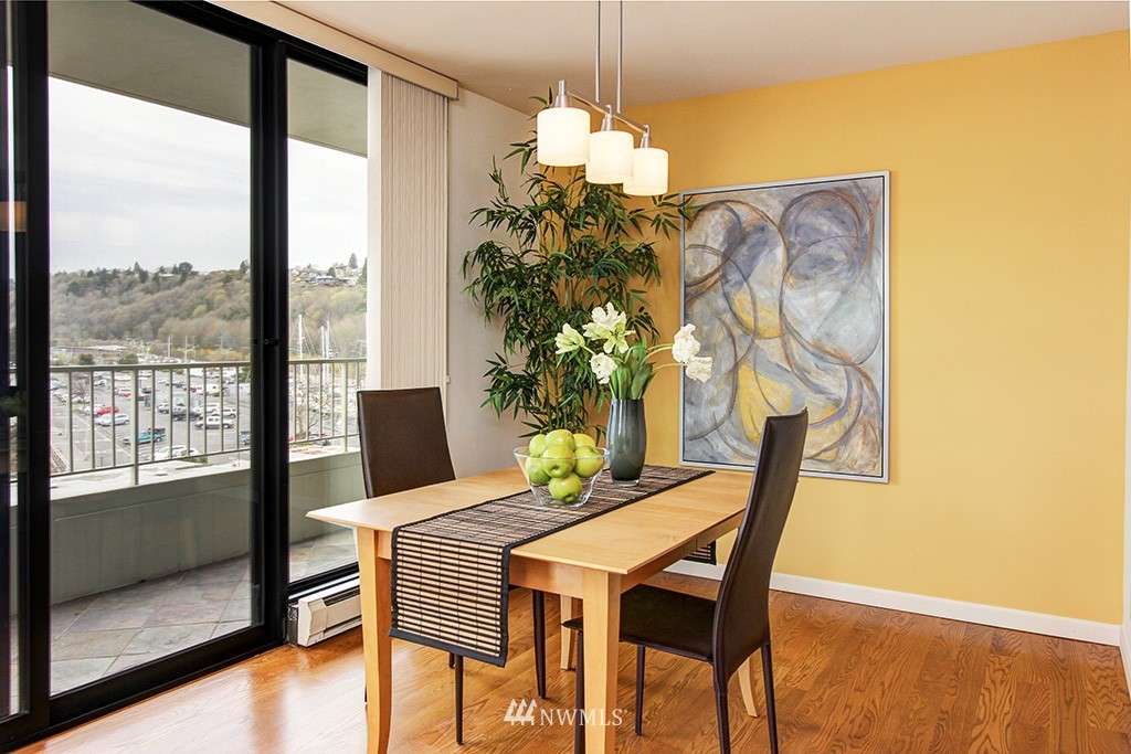 6535 Seaview Avenue Northwest, Unit 601B Seattle, WA 98117 - Photo 4 of 17 a dining room with furniture and wooden floor