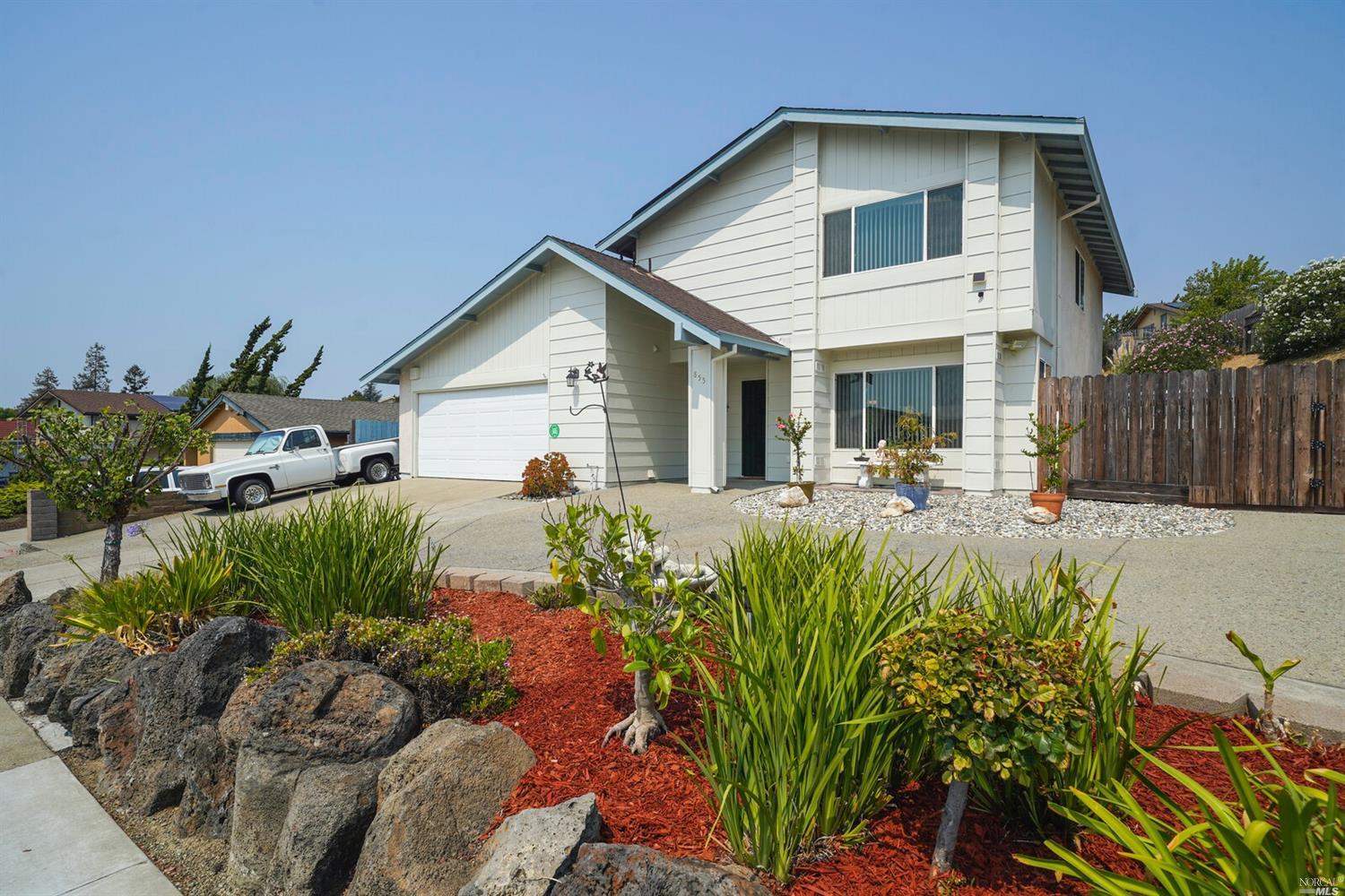 855 Reef Point Drive Rodeo, CA 94572 - Photo 1 of 1 a view of a white house with a flower garden