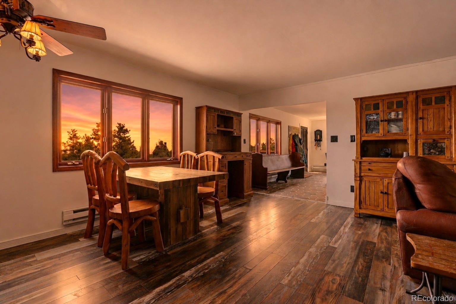 9225 Sandy Lane Conifer, CO 80433 - Photo 13 of 45 a view of a dining room with furniture window and wooden floor