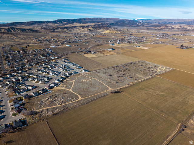 3073 West 500 South Vernal, UT 84078 - Photo 2 of 8 Aerial view of property's location featuring a mountain backdrop and rural landscape