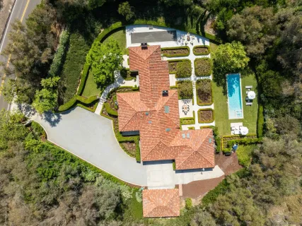 an aerial view of residential houses with outdoor space and street view
