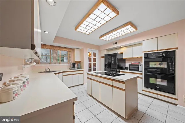 a kitchen with a stove a sink and a refrigerator