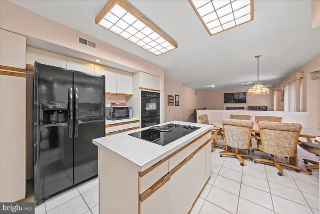 a view of a dining room with furniture and a large window