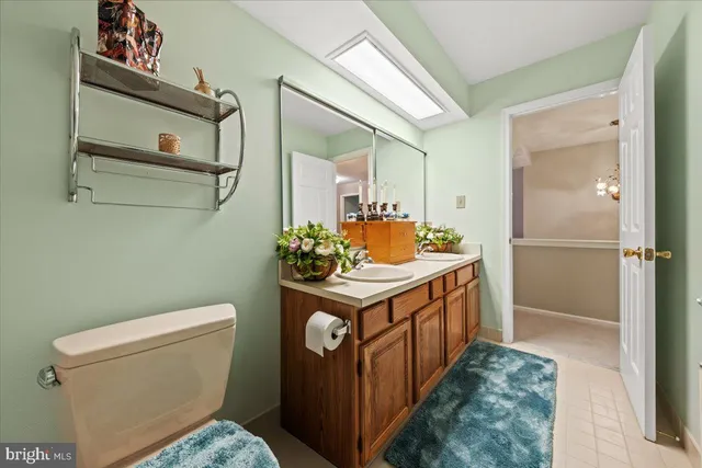 a bedroom with a bed and large windows