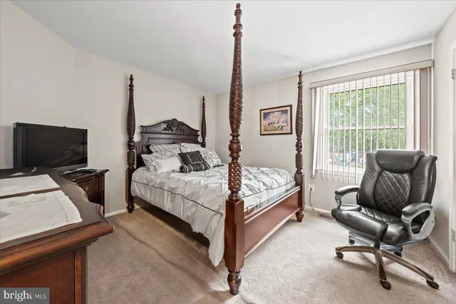 a spacious bedroom with a bed and a couch