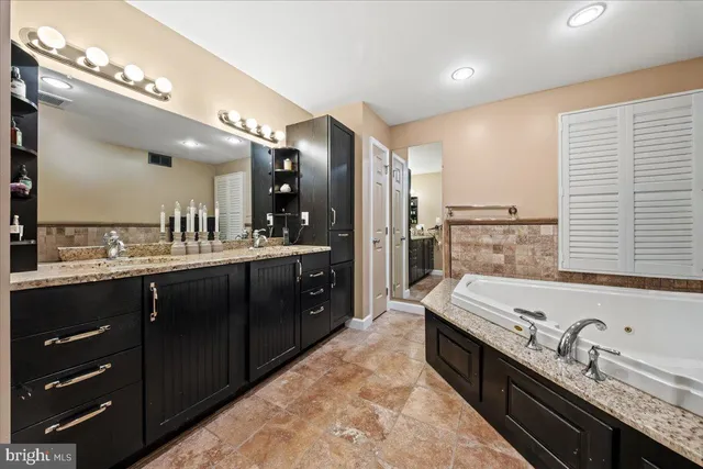 a bathroom with a sink vanity and a mirror