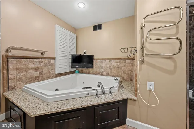 a bathroom with a tub and shower