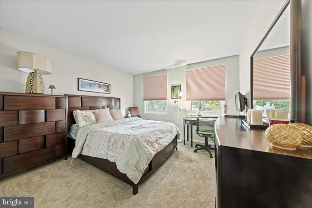 a bed room with a bed and a mirror